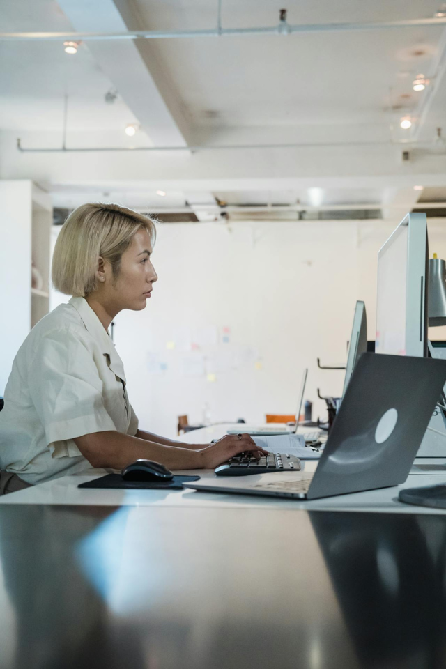 profile-of-a-woman-using-computer-in-a-white-office